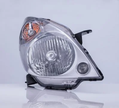 A car headlight on white background with reflection Stock Photos