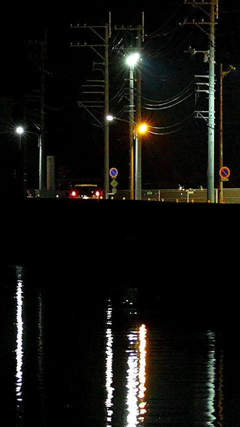 Car Headlights and Wave Reflections on a Lonely Coastal Country Road, 01 Stock Footage 343821541