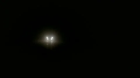 Car headlights of auto driving in thick fog on night road in Torrevieja, Spain. Stock Footage 110836395