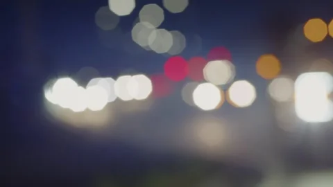 Car Headlights in Blur. Bokeh on a Dark Blurred Background at Night Stock Footage 252951007