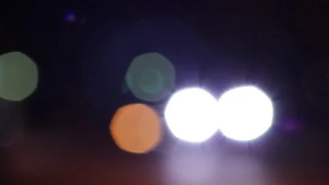 Car headlights bokeh with slight rays Stock Footage 83800224