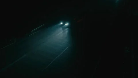 Car Headlights Glowing Brightly While Driving on a Highway During Nighttime Vídeos de archivo 331164312
