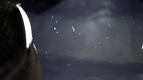Car headlights lighting falling snow in the evening Stock Footage 146549149