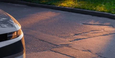 Car hood head light elements on a asphalt road in romantic dramatic sunset li 写真素材