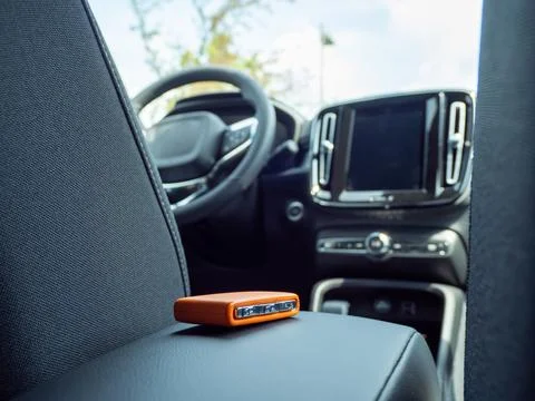Car ignition key on the armrest in the interior of a modern car. Stock Photos