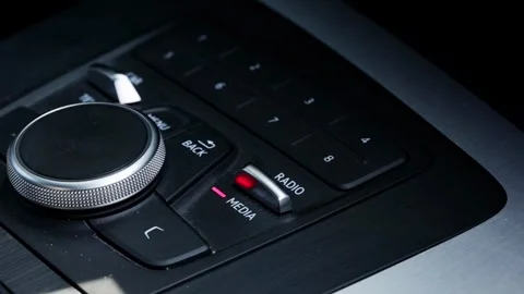 Car infotainment system central control panel with rotary dial and multiple Stock Footage 340385613