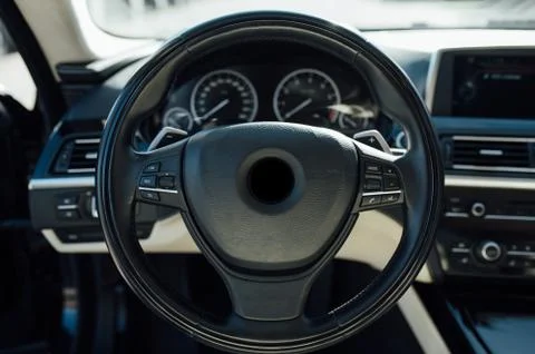 Car inside driver place. Interior of prestige modern car. Front seats with Stock Photos