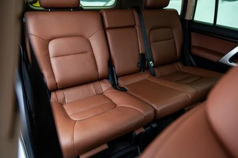 Car inside rear passenger place. Brown interior of prestige modern car. Fro.. Stock Photos