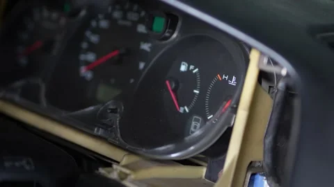 Car instrument cluster dashboard with fuel and temperature gauges partially d Stock Footage 344362023