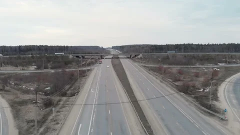 A car interchange with an overpass on a cloudy spring evening in the woods Stock Footage 151886314