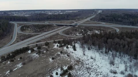 A car interchange with an overpass on a cloudy spring evening in the woods Stock Footage 151953257