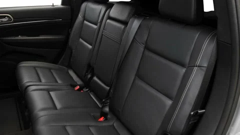 Car interior with back seats and seatbelts  2016 Jeep Grand Cherokee Limited Stock Footage 159875318