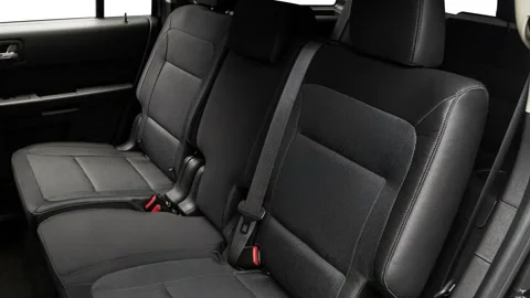 Car interior with back seats and seatbelts  2017 Ford Flex SE Stock Footage 159944223