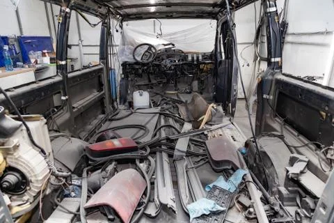 Car interior in the back of a van with a disassembled lining, seats removed,  Stock Photos
