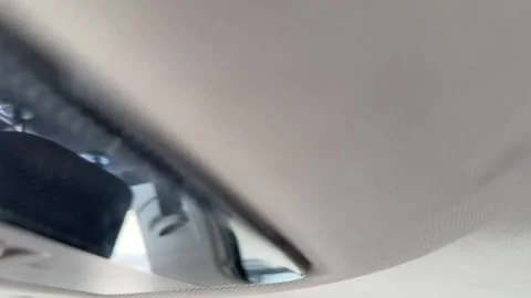 Car interior ceiling light switches off and on through the overhead lamp Stock Footage 337113774