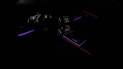 Car interior from driver seat view. Black leather cockpit with ambient light Stock Footage 335938414