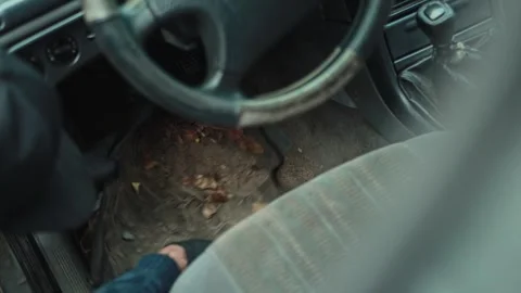 Car interior floor mat covered in dirt and autumn leaves, ready for professional Stock Footage 323910958