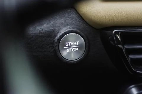 Car interior with illuminated start stop button set in textured leather Stock Photos