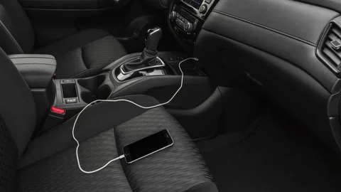Car interior with smartphone plugged into charger  2019 Nissan Rogue SV Stock Footage 160052522