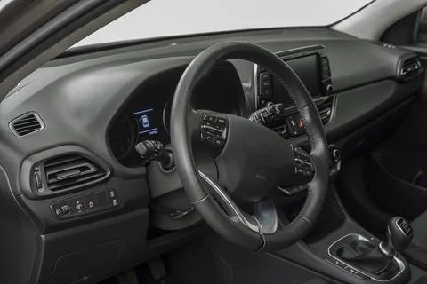Car interior with a steering wheel, control buttons and manual shift Stock Photos