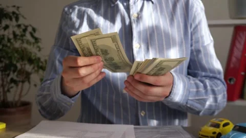 The car invoice in the hands of the businessman 스톡 동영상 311069338