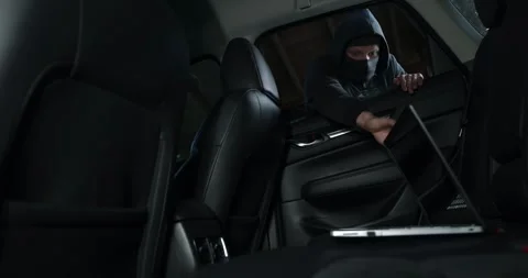 Car items theft - robber steals laptop from car interior through window Stock Footage 339105847