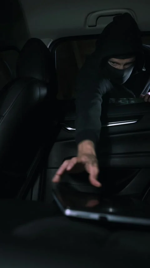 Car items theft - robber steals laptop from car interior through window Stock Footage 339105912