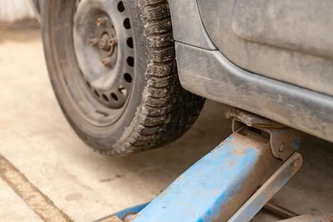 Car on the jack before replacing the wheel Stock Photos