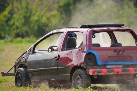 A car is in a junkyard with a man inside Stock Photos