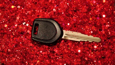 Car key against the background of red glitter Stock Footage 122421829