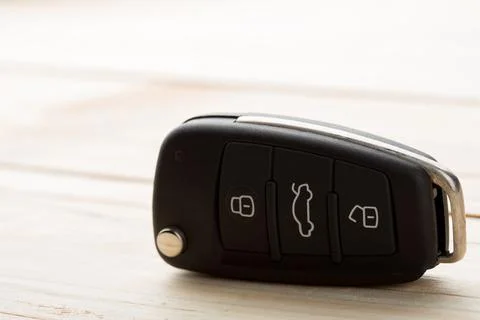 Car key and security remote on the table, concept for rent or buy a new car Stock Photos