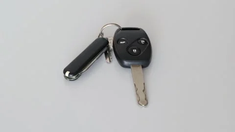 Car key being removed from white table by white hand in slow motion Stock Footage 151030141