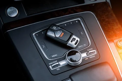 Car key close-up on the gearshift console. Stock Photos