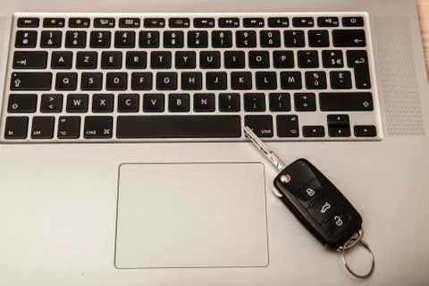 Car key on the computer keyboard Stock Photos