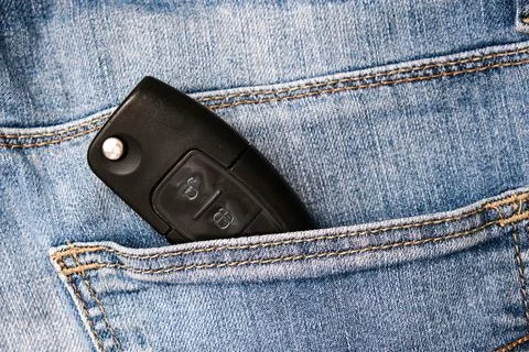 Car key, engine ignition key left in jeans pocket after coming home, weak sec Stock Photos