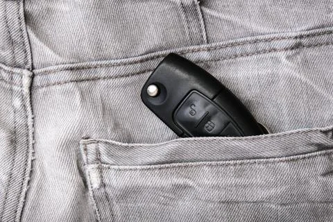 Car key, engine ignition key left in jeans pocket after coming home, weak Stock Photos