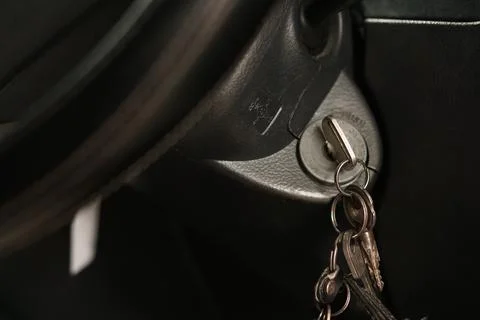 Car key inserted into ignition switch of a vehicle dashboard 스톡 사진