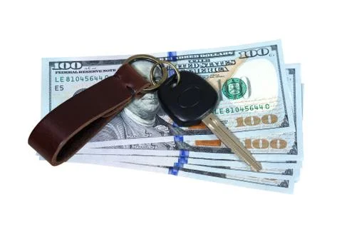 Car key on money isolated on white background Stock Photos