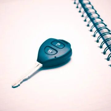 Car key on notebook Stock Photos