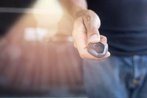 Car key remote on hand. Hand man giving a car key. Stock Photos
