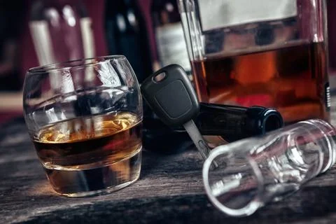 Car key set again glass of brandy Stock Photos