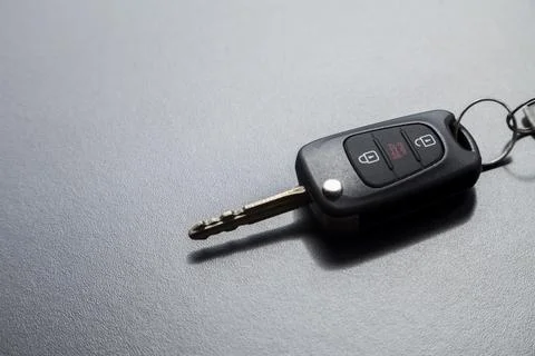 Car key on top of a black table with natural light. Key with buttons to lock  Stock Photos