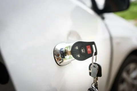 Car keys left in a lock Stock Photos