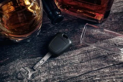 Car keys on the table with empty glass Stock Photos