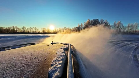 Car kicking up snow dust while driving. Slow motion Stock Footage 332099275