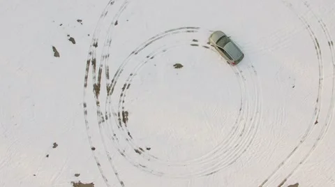 Car leaves round shape trails during ride by snow at winter day Stock Footage 61715965