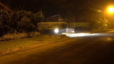 Car Leaves Through Property Gate co Stock Footage 124607718