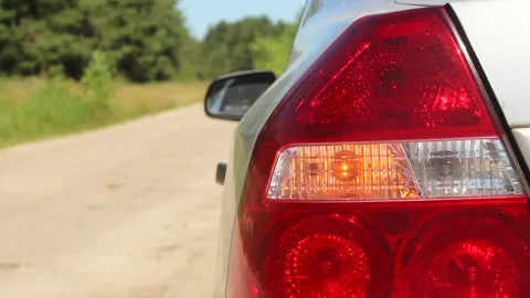 In the car, the left rear direction indicator flashes. Stock Footage 134120692