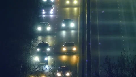 Car lights and side lights in night traffic on all lanes of the highway  Stock Footage 313222524