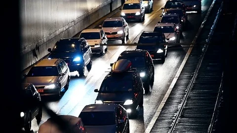 Car lights are seen in a night scene with urban traffic congestion Vídeo Stock 73276092